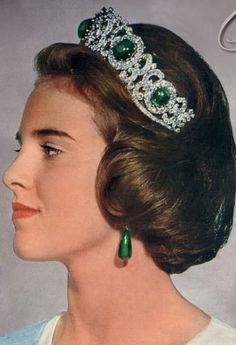 an old photo of a woman wearing a tiara with emeralds on her head