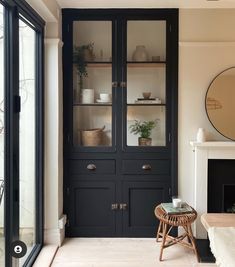 a living room filled with furniture and a fire place in front of a glass door