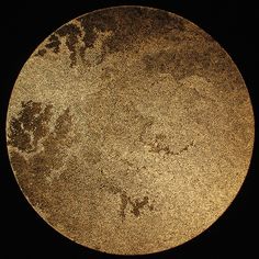 an image of the surface of a round object that looks like it is covered in dirt