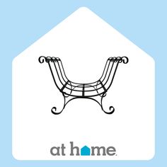 a black iron bench sitting on top of a blue and white house with the words at home above it