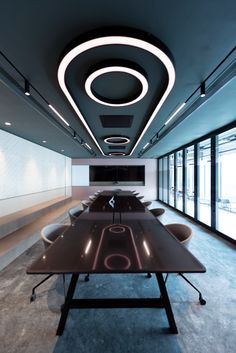 an empty conference room with long tables and chairs