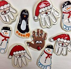 six handprinted christmas ornaments with snowmen and penguins in santa's hats