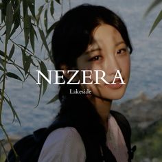 a woman standing next to a tree with the words nezera in front of her