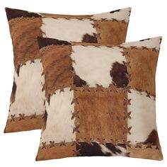 two brown and white cow hide pillows