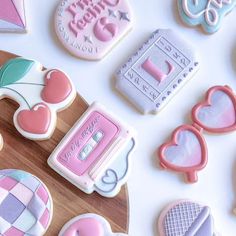 decorated cookies and cookie cutters on a table