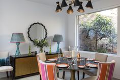 Wonderful fabric from Manuel Canovas instantly introduces colour and positivity into this dining space, beautifully complimenting the William Yeoward table lamp and our favourite Dakota table from Julian Chichester