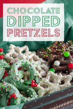 chocolate dipped pretzels are in a box with candy and sprinkles