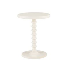 a white table with a round base and beading on the top, against a white background