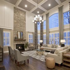 a living room filled with furniture and a fire place in the middle of a room