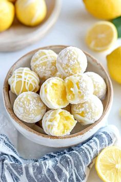 a bowl filled with lemon cookies on top of a table