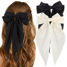 two ponytails with black and white bows on them