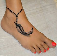 a woman's foot with a feather tattoo on it