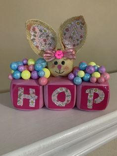 a toy bunny sitting on top of blocks with the word hop spelled out