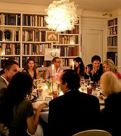 a group of people sitting around a dinner table