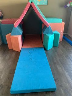 a child's play area with blue and pink foam blocks