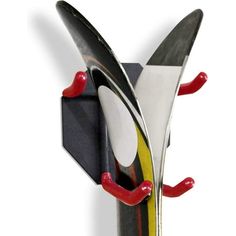 a knife holder with two knives sticking out of it's sides and one has red handles