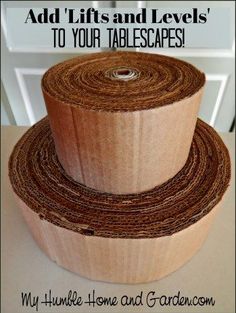 two rolls of brown paper on top of each other with the words, add lifts and levels to your tablescapes make your own