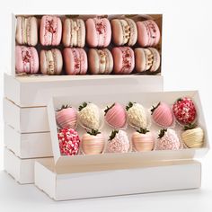 a box filled with lots of pink and white macaroni and cheese covered strawberries