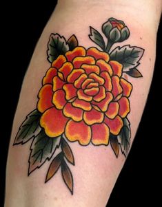 an orange rose tattoo on the arm