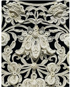 an intricately designed wall panel with flowers and leaves in white on black background by corbe