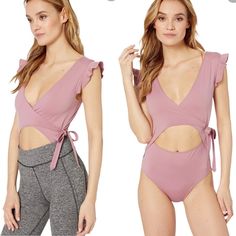 Free People Movement Streamline Ballet Wrap Bodysuit. Ballet Wrap Construction. Ruffled Flutter Sleeves. Front Cut Out Bodysuit. Color: Frosted Berry/Pink. Brand New With Tags. Size Small. Retails $78 89% Polyester, 11% Elastane Pink V-neck Bodysuit For Spring, Pink V-neck Spring Bodysuit, Flirty Spring Beach Bodysuit, Chic Pink Bodysuit For Vacation, Trendy Pink V-neck Swimwear, Chic Pink One-piece Bodysuit, Pink Stretch Bodysuit In Flirty Style, Pink Stretch Flirty Bodysuit, Feminine Pink Sleeveless Bodysuit