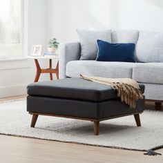 a living room scene with focus on the ottoman