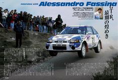 an advertisement for a rally car driving down a road with people watching from the sidelines