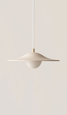 a white pendant light hanging from a ceiling