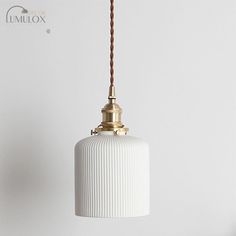 The Alice Rustic Ribbed Capsule Pendant Light in White and Brass seamlessly combines vintage charm with contemporary design. Crafted from high-quality materials, this pendant light features a ribbed glass shade that exudes a warm, inviting glow. The rustic brass accents add a touch of elegance and sophistication to any space. Its versatile white color complements a range of interior styles, making it a perfect addition to your living room, bedroom, or dining area. The adjustable cord allows for easy installation and customization to suit your desired height. Illuminate your home with the classic beauty of the Alice Rustic Ribbed Capsule Pendant Light and create a cozy atmosphere that will impress your guests.Size: 5 to 9 Inch Fixture Width: 3" 5" 5.5" Fixture Height: 8.5" 6" 5" Bulb Includ Antique Pendant Light, Clear Glass Pendant Light, Pendant Light Set, Pendant Light Kit, Ceramic Pendant Light, Ceramic Wall Lights, Bedside Wall Lights, Lamp Pendant, Farmhouse Pendant Lighting