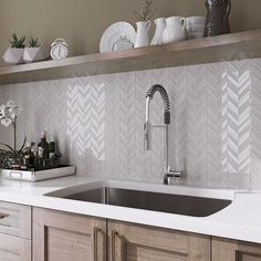 a kitchen sink sitting under a faucet next to a wooden shelf filled with dishes