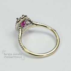 This 18k solid gold Vintage Ring has a sparkly red ruby as its center piece. Diamond rounds decorate a halo around the ruby as well as part of the shank Ring Size: 5.75 Total Weight: 2.87 grams Precious Metal: 18k solid gold Precious stones: -Reddish Orange Sapphire Center Stone: 0.24 carats, 5.7mm x 7.1mm -White Round Diamonds: 0.24 carats Fine Jewelry Yellow Gold Sapphire Ring With Halo Setting, Fine Jewelry Yellow Gold Ruby Ring With Halo Design, Yellow Gold Sapphire Ring With Halo Setting, Yellow Gold Ruby Rings With Halo Design, Round Cut Ruby Promise Ring With Center Stone, Formal Pink Sapphire Diamond Ring With Halo Setting, Ruby Diamond Ring With Accent Stones And Round Cut, Anniversary Ruby Ring With Center Stone In Round Band, Fine Jewelry 14k Gold Halo Ring With Center Stone