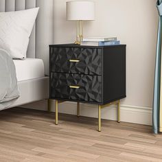 a black and gold nightstand next to a bed