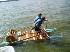 two people on a raft in the water with oars and paddles attached to it