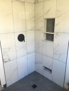 the shower is white and has black tile