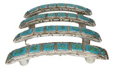 three pieces of silver and turquoise colored stones