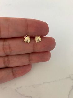 "14K Bezel Ladybug Earrings, Dainty Earrings, Women Earrings, Kid Earrings, Solid Gold Ladybugs, Gold Ladybugs, Gold Earrings ♦ Materials: 14kt Solid Gold, Stone: Cubic Zirconia ♦ Available colors: Clear Cubic Zirconia on Yellow Gold ♦ Closure: Screw Backs ♦ Earrings Measurements: 7x6 (LxW) Millimeters -------------------------------------------------- ♦ -------------------------------------------------- PRODUCTION TIMES Order processing time varies between 1-2 business days, we work on our piec Kid Earrings, Ladybug Earrings, Emerald Earrings Studs, Gold Bridal Earrings, Opal Earrings Stud, Gemstone Stud Earrings, Women Earrings, Kids Earrings, Opal Studs