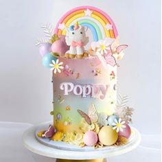 there is a colorful cake with an unicorn on top