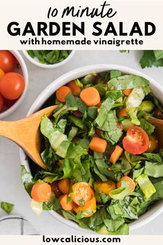 a salad with carrots and lettuce in a white bowl on a table