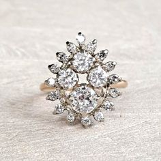 "Antique Diamond Cluster Ring 14K Yellow and White Gold Art Deco 1.59 CTW Old European & Round Brilliant! GIA G.G. Appraisal Incl 6,260 Usd! This amaaaazing ring will be cherised by the vintage loving woman who likes to make a statement! The crown is large and measures approximately mm x mm, forming a pear shaped cluster, and rises mm from the finger. It has a WOW presence on the hand, beautiful without being gaudy. The largest diamond is .60 carat, SI1 clarity and G color and is an old european Luxury Pear-shaped Diamond Ring With 17 Jewels, White Marquise Diamond Ring With 17 Jewels, Luxury 14k White Gold Diamond Ring With 17 Jewels, Yellow Gold Cluster Ring With 17 Jewels, Timeless White Cluster Ring With Rose Cut Diamonds, Marquise Diamond White Ring With 17 Jewels, White Cluster Diamond Ring In 14k Gold, 14k Gold Cluster Wedding Ring With Single Cut Diamonds, White 14k Gold Cluster Diamond Ring