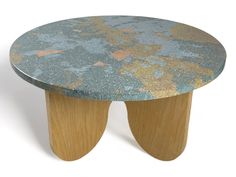 an artistically designed wooden stool with blue and gold paint splattered on it