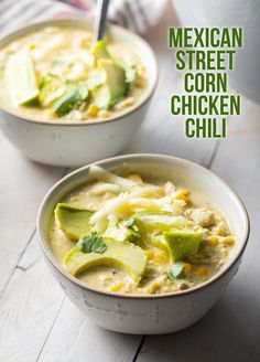 two bowls of mexican street corn chicken chili with avocado and cilantro