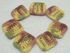 six crocheted squares arranged in the shape of a circle on a white surface