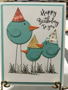 a birthday card with two birds wearing party hats