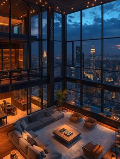 a living room filled with lots of furniture and large windows overlooking the city at night