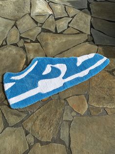 a blue and white towel sitting on top of a stone floor