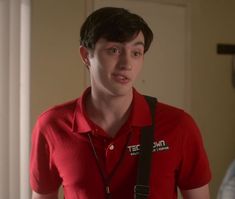 a young man in a red shirt with a stethoscope around his neck