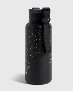 a black water bottle with gold stars on the side and a black strap around it