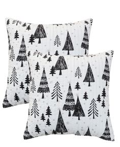 two black and white pillows with trees on them