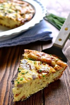 a piece of quiche sitting on top of a wooden table