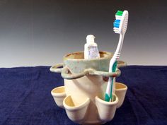 two toothbrushes are sitting in a cup